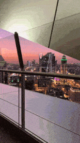 a view of a city from a balcony with a building that says ' allianz ' on it
