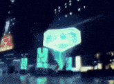 a blurred image of a city at night with a sign that says ' a ' on it