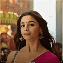a painting of a woman with a nose ring and earrings