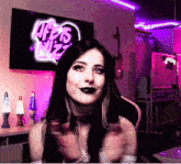 a woman sitting in front of a life 's wiz logo