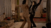 a man in a leather jacket is standing in front of a woman in a chair