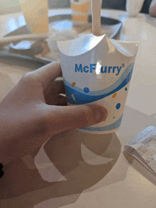 a person holding a cup that says mcfurry