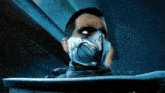 a man with a mask on his face is looking at something .