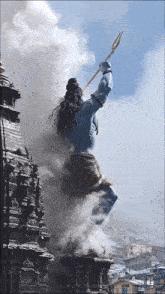 a statue of a man with a spear in his hand is surrounded by smoke
