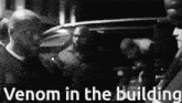 a black and white photo with the words venom in the building on the bottom