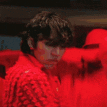a blurry picture of a person with red hearts surrounding them