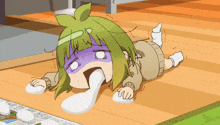 a cartoon girl with green hair is laying on the floor