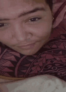a close up of a man 's face with a tattoo on his forehead