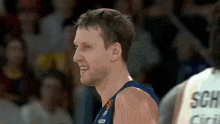a basketball player is smiling while wearing a jersey with the word son on it
