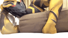 a person in a superhero costume is laying on a couch