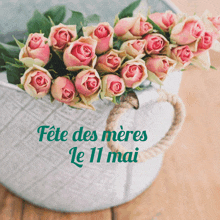 a bouquet of pink roses in a basket with the words fête des meres le 11 mai below it