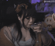 a woman wearing a cat ear headband and headphones has the hashtag @ruuna_070 on the bottom right