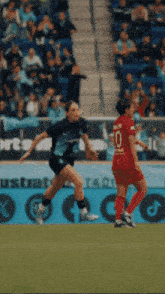 a soccer player wearing a number 10 jersey runs towards another player