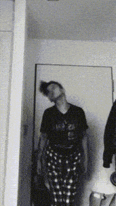 a man standing in front of a door with his head turned to the side