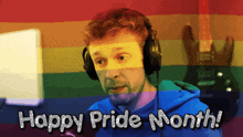 a man wearing headphones in front of a rainbow flag says happy pride month