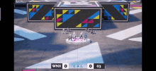 a group of people are standing on a stage with a scoreboard that says wnx 0 and 03
