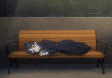a girl is laying on a wooden bench with her head on it
