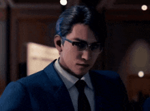 a man in a suit and tie wearing glasses looks at the camera