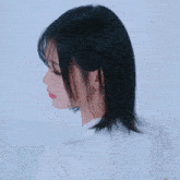 a woman with short black hair and bangs is smiling for the camera