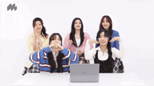 a group of girls are sitting at a table with hearts coming out of their faces
