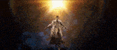 a statue of a man with his arms outstretched in front of a bright light .