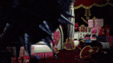 a room filled with lots of pink boxes and a large blue object with spikes
