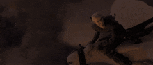 a dragon is flying through the clouds in a dark sky