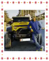 a man in a blue hoodie leans against a yellow jeep with a license plate that says ' dubai ' on it