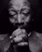 a black and white photo of a man with a tattoo on his chest