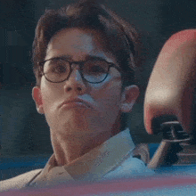 a man wearing glasses makes a funny face