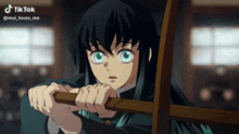 a girl with long black hair and blue eyes is holding a wooden stick in her hands and a tiktok video is displayed