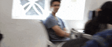 a blurry picture of a man wearing glasses and a name tag