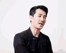 a man with a mustache is making a funny face