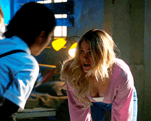 a woman in a pink sweater with the letter a on it