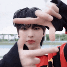 a person is making a frame with their hands