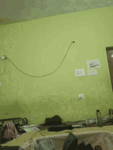 a room with a green wall and a few electrical outlets on it