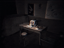 a computer on a desk in a dark room with a drawing on the wall that says " i love you "