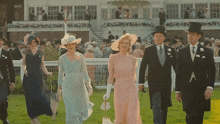 a group of people wearing hats and dresses are walking across a field