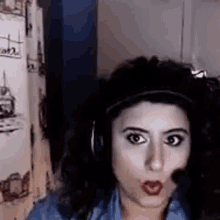 a woman is wearing headphones and making a face .
