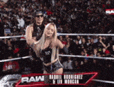 raquel rodriguez and liv morgan wrestling in a ring