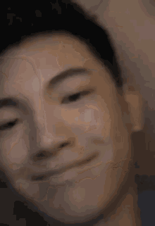 a close up of a man 's face with a smile on his face .