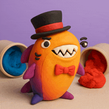 a monster made out of clay wearing a top hat and bow tie