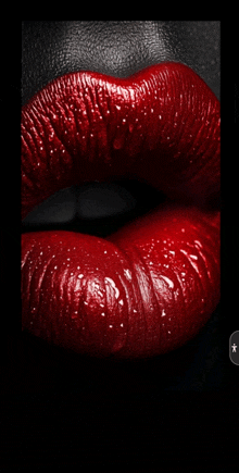 a close up of a woman 's lips with red lipstick and water drops