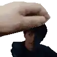 a pixelated image of a hand putting a towel on a man 's head