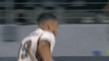 a football player wearing a white jersey with the number 23 on it