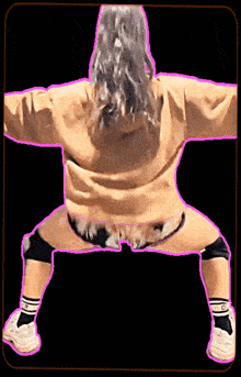 a woman wearing a hoodie and shorts is squatting down