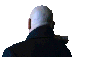 a bald man in a black coat looks to his left