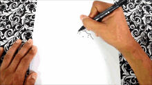 a person is drawing with a pen that says ' mitsubishi ' on the side