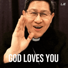 a man with glasses says god loves you in white letters