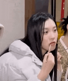 a woman is eating food with chopsticks and a spoon .